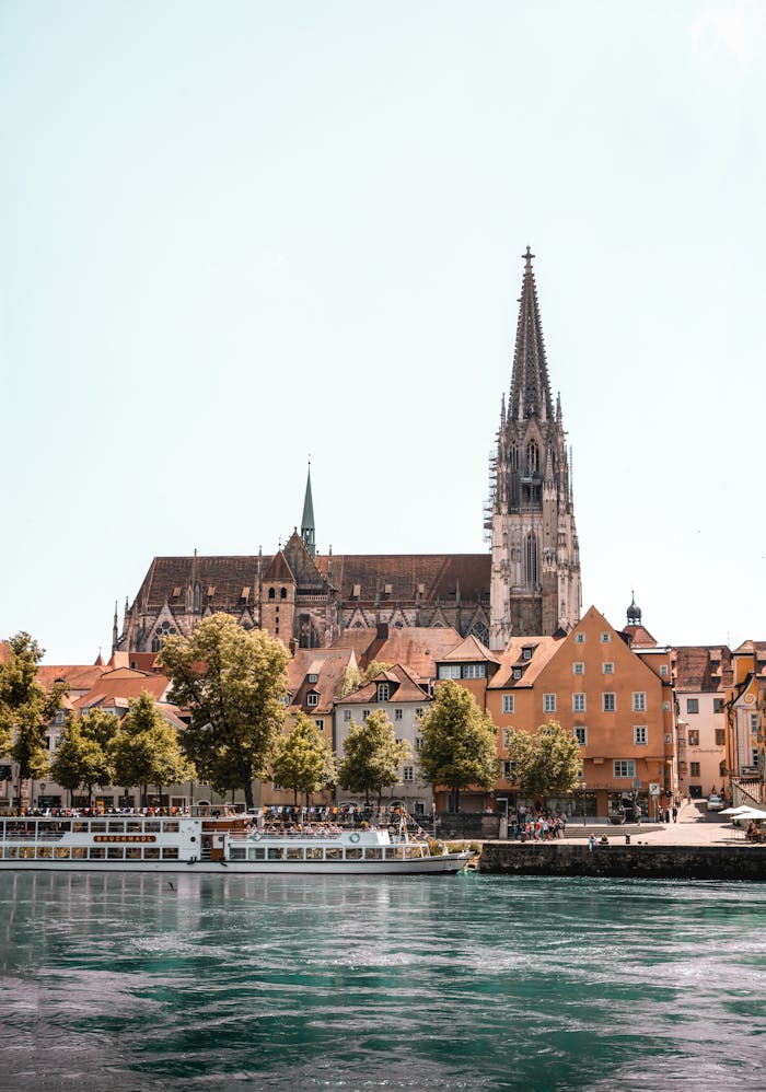 pexels photo 24536249 Scenic view of Regensburg Cathedral and city architecture along the Danube River.