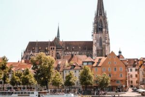 Ruhestandsplanung Regensburg Scenic view of Regensburg Cathedral and city architecture along the Danube River.